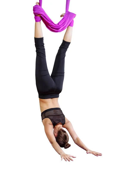 Young woman practicing supported shoulder stand asana in yoga