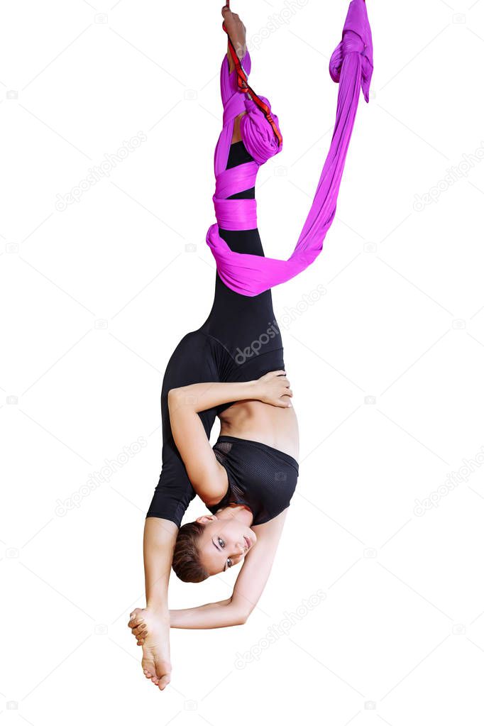 Young beautiful woman practicing aerial yoga on a white isolate.
