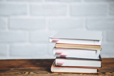 Ahşap masa üzerinde ciltli kitap yığını. Okula dönüş. Kopya alanı