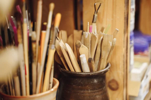 Набор кистей и инструментов для рисования на столе в мастерской художника — стоковое фото