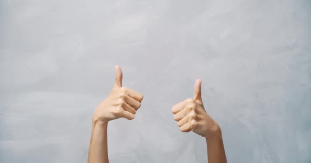 Close Female Hands Showing Thumbs Grey Background Copy Space — Stock Video