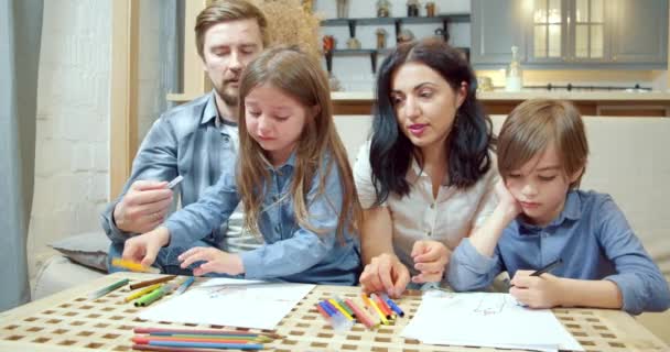 Счастливая Творческая Семья Двумя Милыми Детьми Рисующими Цветными Ручками Фломастерами — стоковое видео