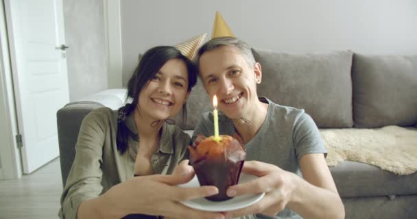 Casal Feliz Blogueiros Bonés Aniversário Gravando Vídeo Soprando Uma Vela — Vídeo de Stock