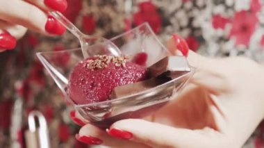 Lezzetli meyveli dondurmanın yakın planında genç bir kadının ellerinde çikolata parçaları var..