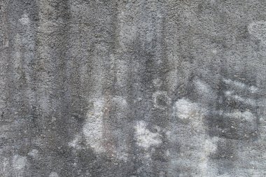 Grunge parçası portre bir binanın duvarına yıpranmış. Çimento zemin.