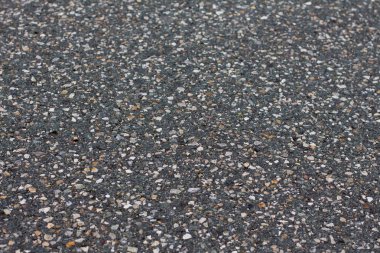 Düz koyu gri asfalt kaplama doku küçük kayalar ile