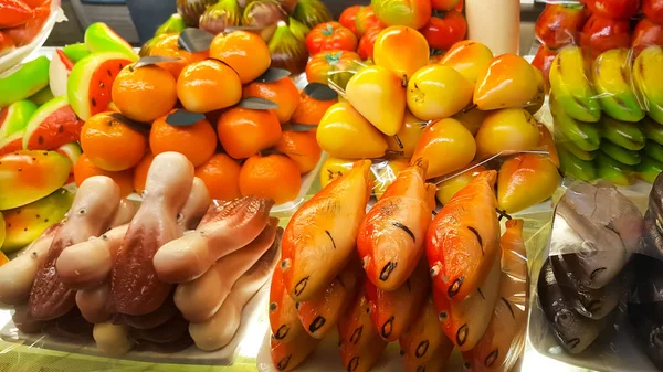 An assortment of fruit shaped marzipan - octopus, fish, fruits, tangerines, pears, watermelon in Venice, Italy