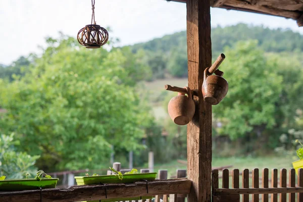 Wooden porch of an old vintage country house overlooking towards a green sunny garden in the yard — Stock Photo, Image