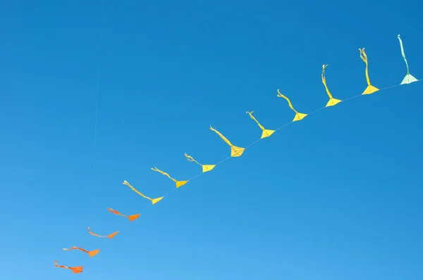 Colorful kites flying in blue sky — Stock Photo, Image