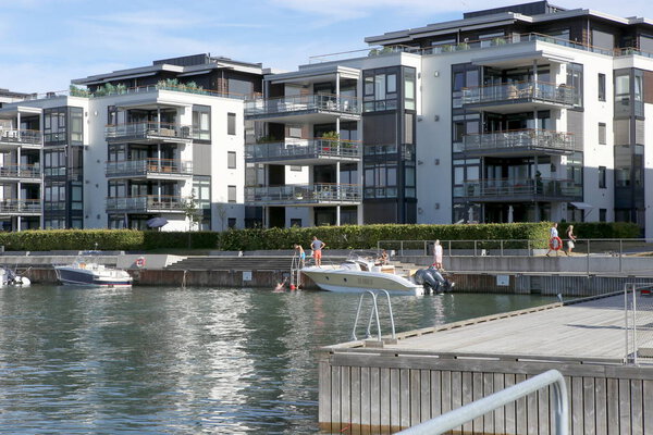 Oslo, Norway - July 23, 2018: Apartment buildings on the Oslo fjord in Fornebu district. Luxury apartments with terraces for sunbathing and swimming near ocean.