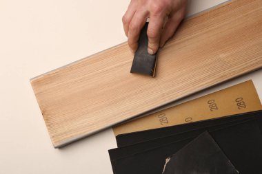 Adam el ahşap kurulu zımpara kullanarak yumuşatma. Zımparalama ve parlatma ahşap melez (bitki) plank.