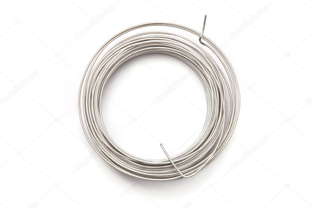 Coil of stainless steel wire isolated on white background.  Stack of stainless steel metal wire top view.
