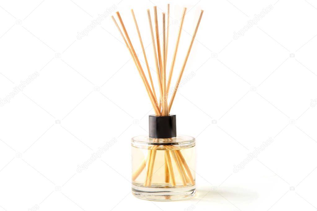 Air refresher bottle and wooden sticks isolated over white background. Aromatic sticks for home.