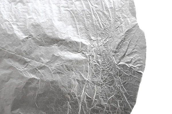 Aluminum crumpled foil sheet isolated on white background. Silver baking foil texture.