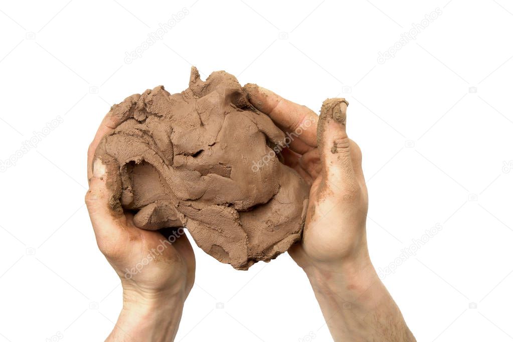 Natural clay piece in hands  isolated on white background.  Wet clay material for sculpting or modeling.