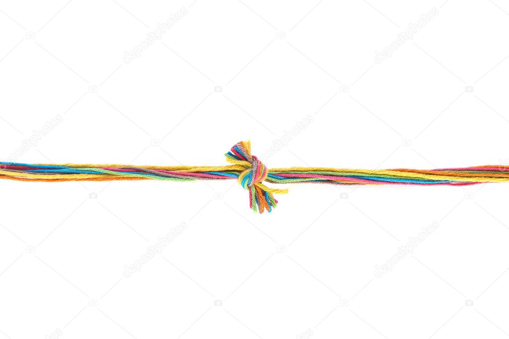 Colorful knot of cotton thread isolated on white background. Thread line with knot made of different color pink, green, yellow, blue, orange thread mix.