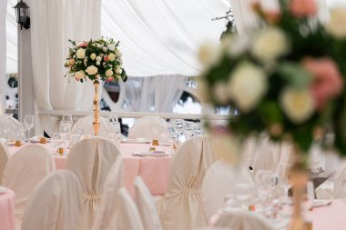 Düğün partisi için çok güzel bir dekor. Çiçek, çeşitli lüks cam ve mum tasarımları. Seçici odaklanma. Muhteşem düğün sandalyesi ve açık havada güzel bir akşam yemeği için sofra hazırlamak muhteşem bir düğün sandalyesi ve açık havada güzel bir yemek için sofra hazırlamak.