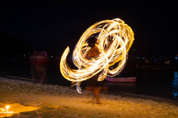 Amazing fire dancers Swing fire dancing show fire show on the beach  in Thailand