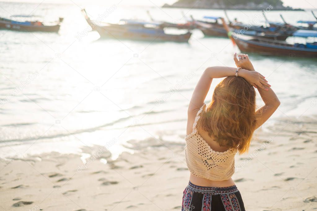 Happy Girl Enjoying Beautiful Sunrise on the beach in Satun, Thailand