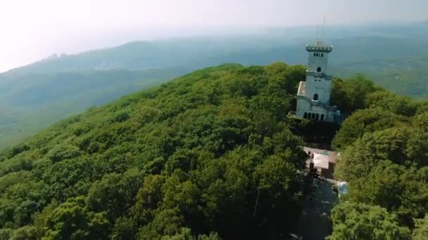 Vue aérienne 4k. Beau château sur la montagne par une journée ensoleillée d'été, vue sur les montagnes et la mer — Video