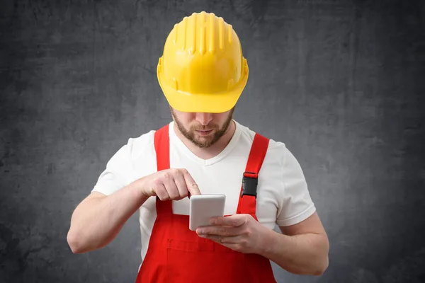 Travailleur de la construction utilisant un smartphone — Photo