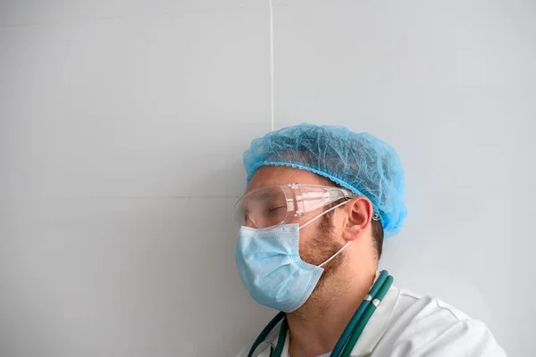 Exhausted doctor with closed eyes in face mask — Stock Photo, Image