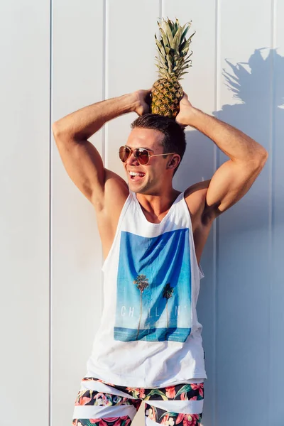 Schöner Mann hält sich im Freien eine Ananas auf den Kopf — Stockfoto