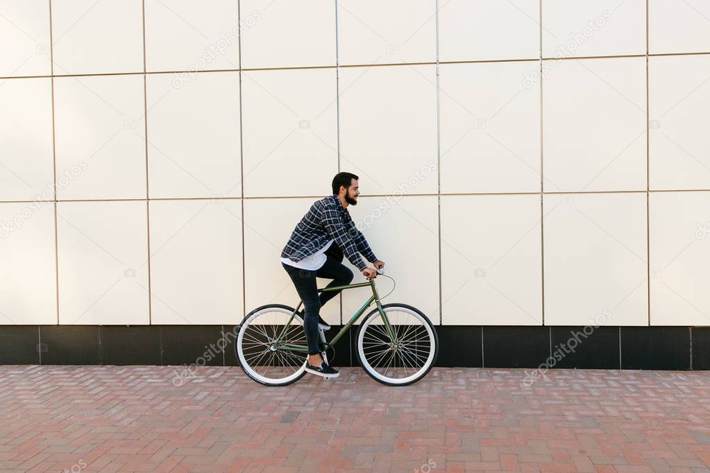 Side view of male riding a bike, outdoors