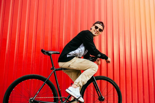 Smiling guy riding a bike, outdoors. — Stock Photo, Image