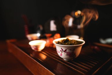 Traditional Chinese tea ceremony. Porcelain gaiwan with tea. Soft selective focus. clipart