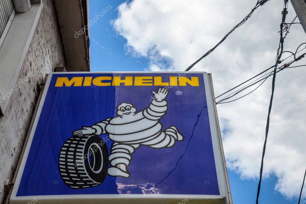 BELGRADE, SERBIA - JUNE 24, 2018: Michelin logo on a tire store in a Serbian garage. Michelin is a French tyre manufacturer spread worldwide