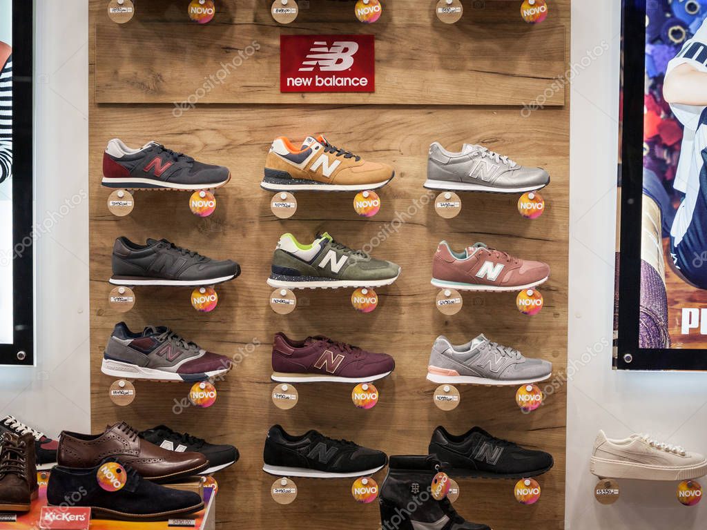 BELGRADE, SERBIA - SEPTEMBER 2, 2018: New Balance logo and sneakers on display in the window of their main retailer in Belgrade. New Balance is an American sports footwear company