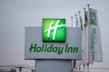 BELGRADE, SERBIA - OCTOBER 2, 2018: Holiday Inn logo on a sign in front of their main hotel in Serbia. Holiday Inn is a worldwide brand of hotels, part of the InterContinental Group clipart