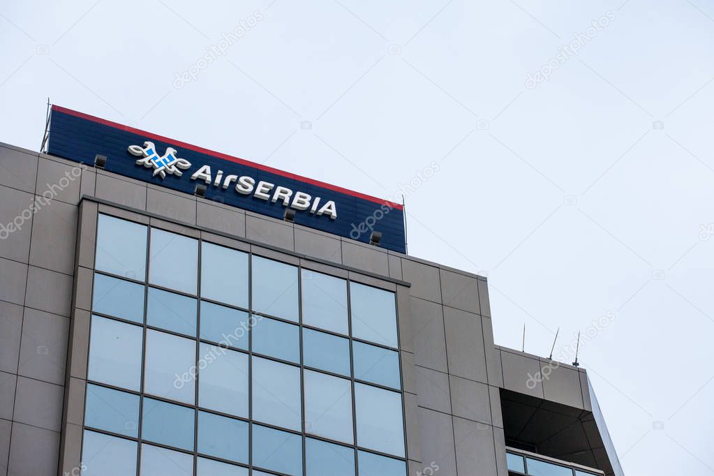 BELGRADE, SERBIA - OCTOBER 2, 2018:  Logo of Air Serbia, on their main office at dusk. Air Serbia, partly belonging to Etihad, is flag airline carrier of Serbia