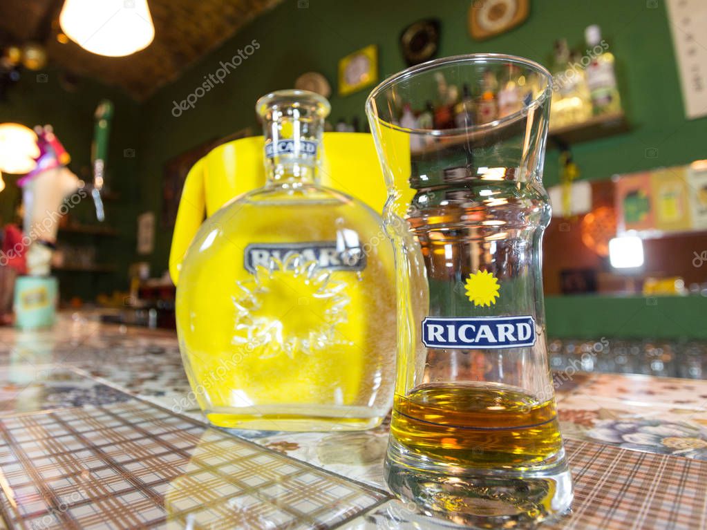 MARSEILLE, FRANCE - MARCH 15, 2018: Close of on a Ricard jug and a water bottle with its logo. Ricard is a pastis, an anise and licorice flavored aperitif typical from Southern France