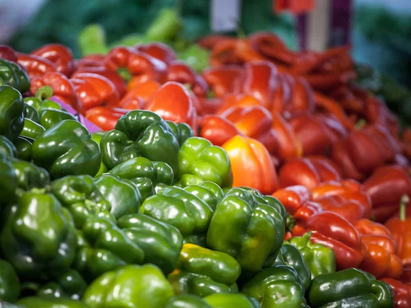Red and green bell peppers for sale on a market of Canada. Peppers are a vegetal typical from the autumn