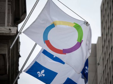 MONTREAL, CANADA - NOVEMBER 8, 2018: Organisation Internationale de la Francophonie flag next to the flag of Quebec in Montreal. It is the francophony organization coordinating french speaking in the world clipart