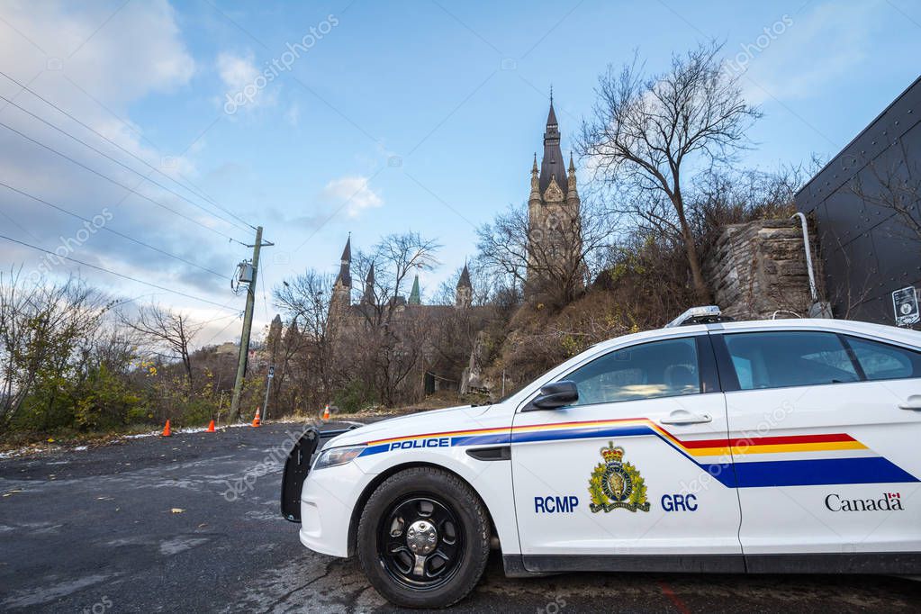 MONTREAL, CANADA - NOVEMBER 10, 2018: RCMP GRC Police car standing in front of the Canadian Parliament Building. The Royal Canadian Mounted Police is the Federal police of Canada