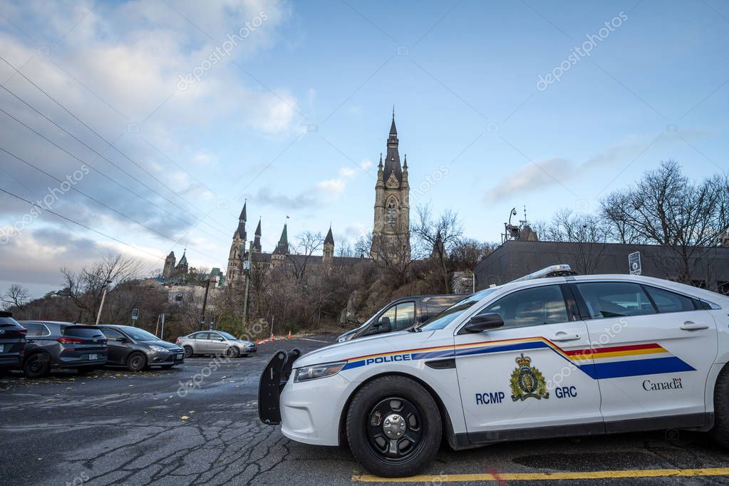 MONTREAL, CANADA - NOVEMBER 10, 2018: RCMP GRC Police car standing in front of the Canadian Parliament Building. The Royal Canadian Mounted Police is the Federal police of Canada