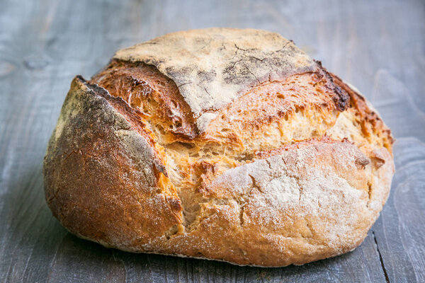 Loafs (or miche) of French sourdough, called as well as Pain de campagne, on display on a wooden table. Pain de Campagne is a typical French huge loaf of bread abiding by the traditional codes