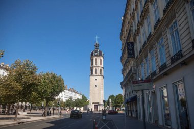 LYON, FRANCE - JULY 19, 2019: Clocher de la Charite Clocktower on the Place Bellecour square in summer. It is the remaining of a former hospital and a major landmark of Lyon Center clipart