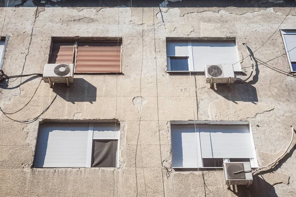 Air Conditioning Units, or AC, on display with their fans on a decaying facade of an old building of Belgrade, Serbia, Europe. They are used to cool down interiors, but consume a lot of electricity