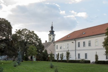 SREMSKA MITROVICA, SERBIA - SEPTEMBER 24, 2016: Panorama of the istorijski arhiv, the national archive, and the Vmuc Dimitrije orthodox church in Sremska Mitrovica, in the city center clipart