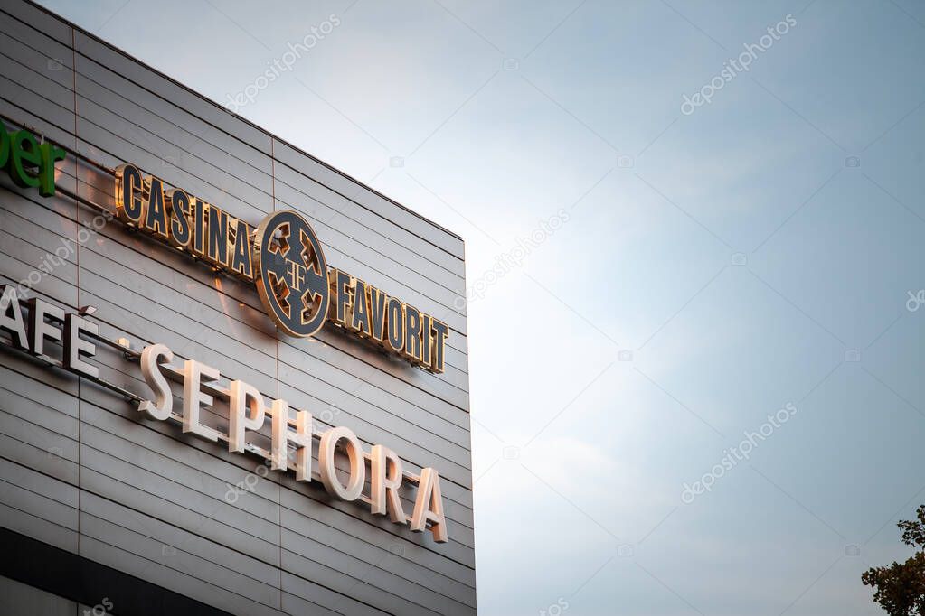 BELGRADE, SERBIA - MARCH 15, 2025: Metal-clad mall corner in Belgrade bears two brands: gold 