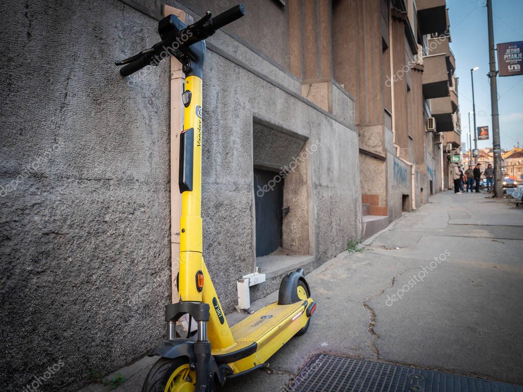 BELGRADE, SERBIA - OCTOBER 1, 2023: Yellow Yandex Go electric scooter in belgrade, Yandex go is a russian shared micro mobility application specialized in taxis and electric scooter rental.