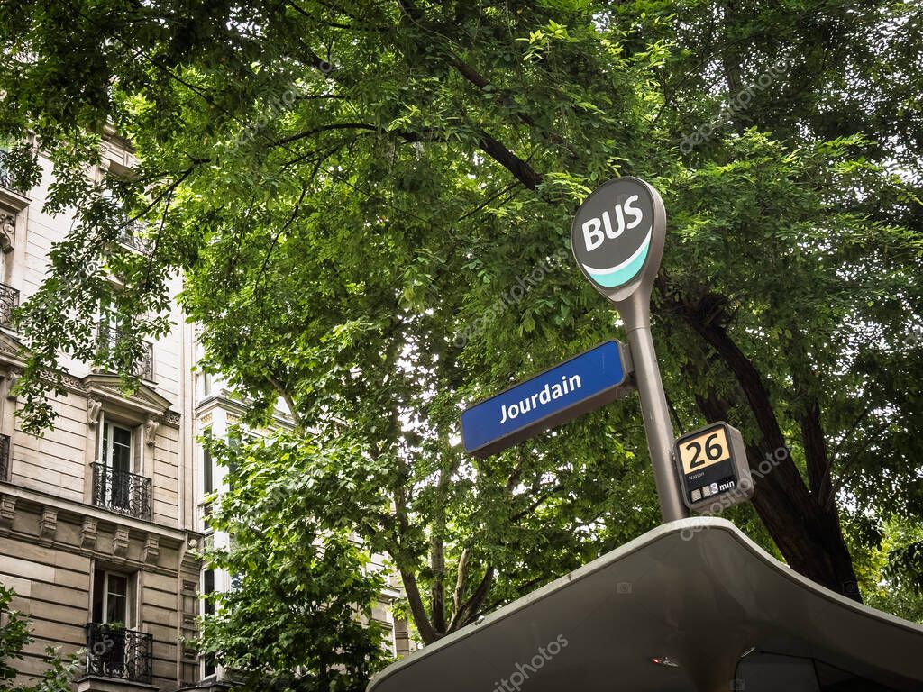 PARIS, FRANCE - JUNE 25, 2025: Paris bus stop at Jourdain, showing the round BUS emblem, route indicator for line 26, representing RATP public transport in the city.