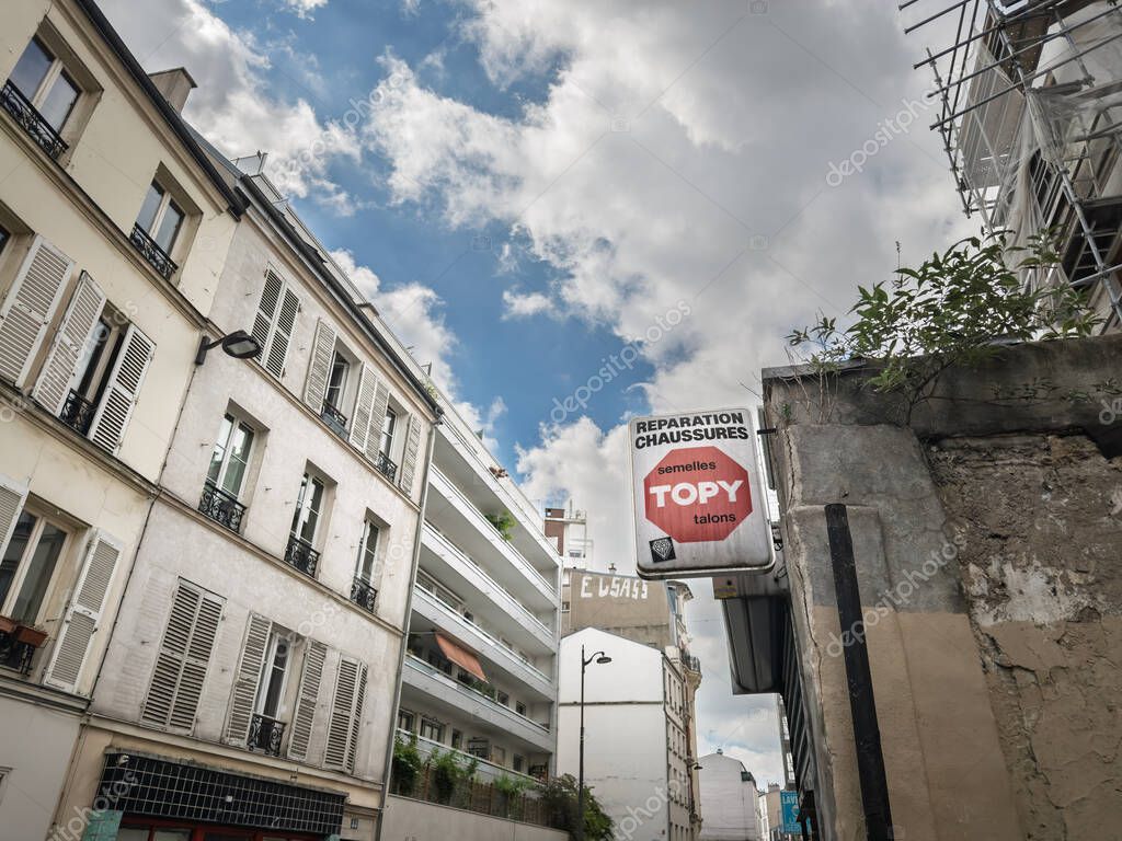 PARIS, FRANCE - JUNE 28, 2025: Topy sign outside a cobbler shoe repair boutique in Paris 