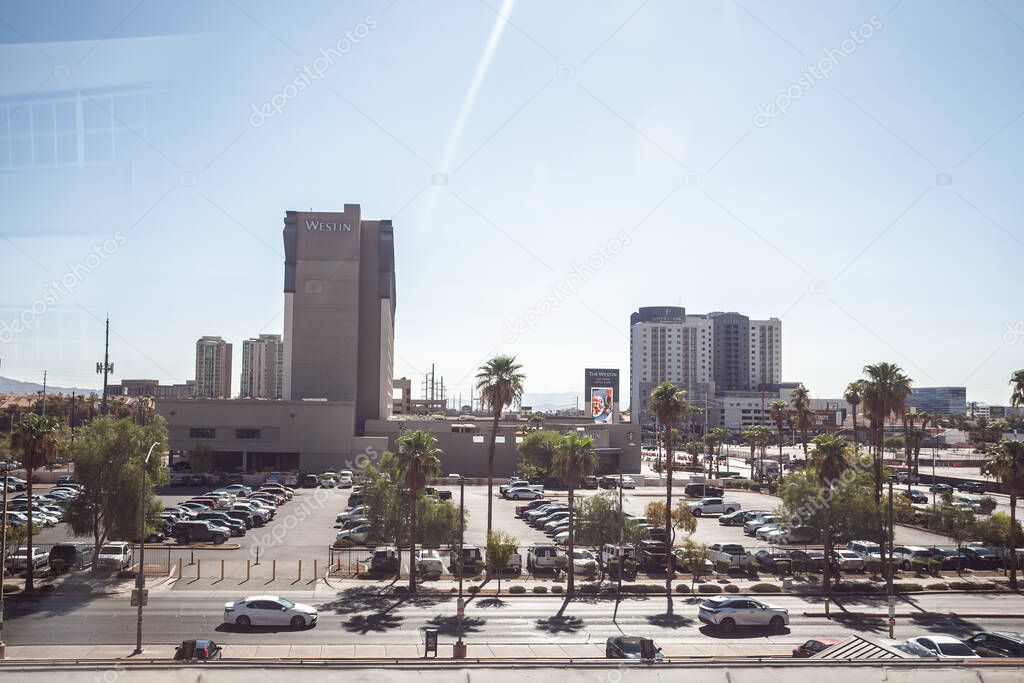 LAS VEGAS - AUGUST 19, 2024: Westin Las Vegas and its surrounding surface parking lot, with palm trees, street traffic, and midrise hotels, the backdrop of the resort corridor.