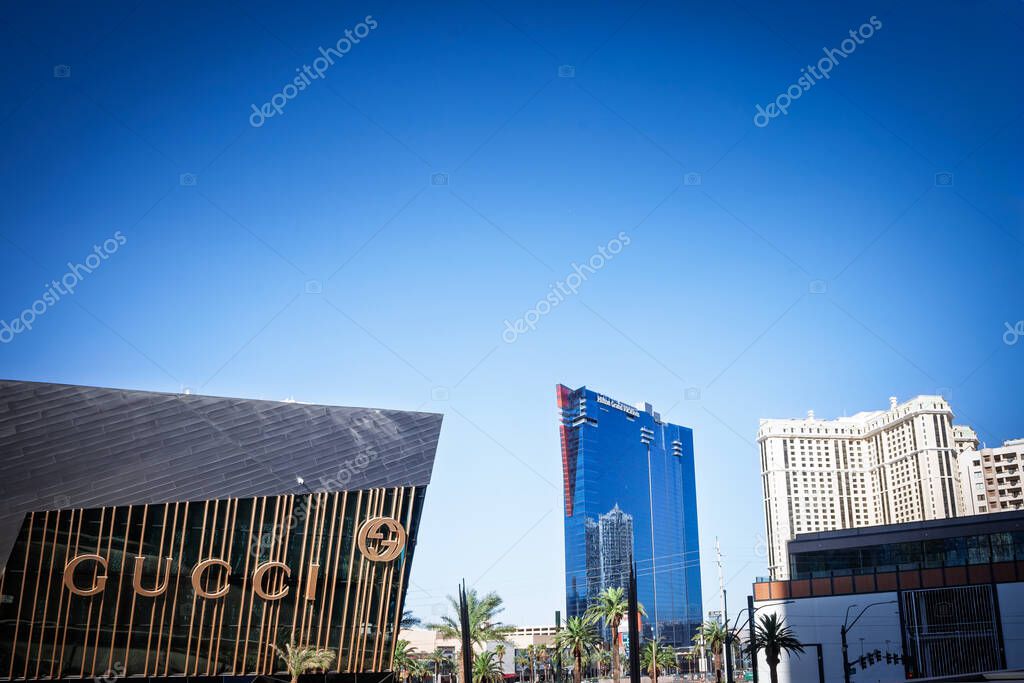 LAS VEGAS - AUGUST 24, 2024: Gucci storefront on a facade along the Las Vegas Strip, while the blue Hilton Grand Vacations tower (elara tower) rises in the background.