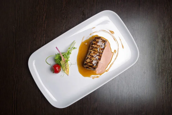 Meat steak with vegetables sauce teriyaki, On a white plate, on a wooden board. view top